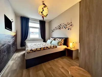 Ein Bett oder Betten in einem Zimmer der Unterkunft Ferienwohnung Midgard im Sagenharz - Family-Apartment, 2 SZ & WLAN