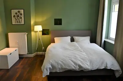 Ein Bett oder Betten in einem Zimmer der Unterkunft Ferienwohnung Villa Augusta-Bel Etage mit Infrarotkabine