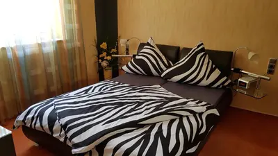 Ein Bett oder Betten in einem Zimmer der Unterkunft ALACARD Ferienwohnungen Höffgen Thale Harz