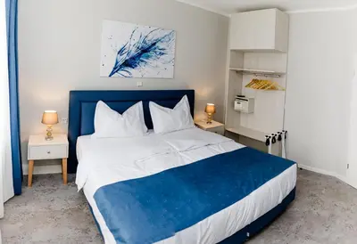 Ein Bett oder Betten in einem Zimmer der Unterkunft Aneton Garni Hotel