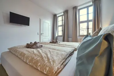 Ein Bett oder Betten in einem Zimmer der Unterkunft Ferienresidenzen Marktplatz - exklusive Ferienwohnungen mit Fahrstuhl