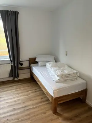 Ein Bett oder Betten in einem Zimmer der Unterkunft Ferienwohnung Rathauswiese