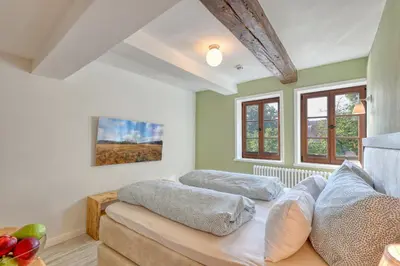 Ein Bett oder Betten in einem Zimmer der Unterkunft Ferienwohnungen Steinweg 61