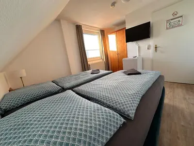Ein Bett oder Betten in einem Zimmer der Unterkunft Gästehaus am Harz
