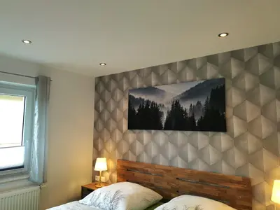 Ein Bett oder Betten in einem Zimmer der Unterkunft DAS Ferienhaus Waldblick