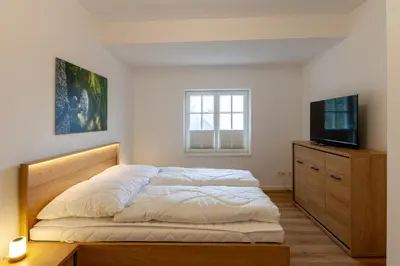 Ein Bett oder Betten in einem Zimmer der Unterkunft Ferienwohnung Hirschmann 5 mit Kamin