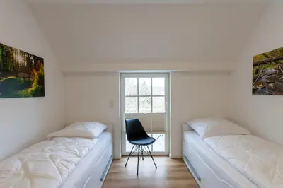 Ein Bett oder Betten in einem Zimmer der Unterkunft Ferienwohnung Hirschmann 7 mit Sauna, Kamin, Balkon