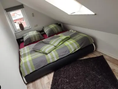 Ein Bett oder Betten in einem Zimmer der Unterkunft Ferienwohnung zur alten Schneiderei