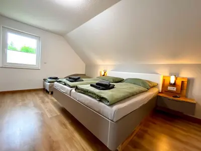Ein Bett oder Betten in einem Zimmer der Unterkunft Doppelferienhäuser Harzlicht und Hexenpfad