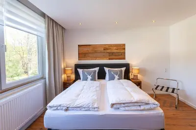 Ein Bett oder Betten in einem Zimmer der Unterkunft Ferienwohnung Waldfrieden 3 mit Dachterrasse und Grill