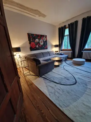 Ein Bett oder Betten in einem Zimmer der Unterkunft Harziano in der Kaiser-Otto-Straße - Stilvolle Gründerzeitwohnungen mit Kachelöfen, Wintergarten & viel Platz zum Entspannen