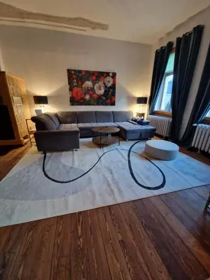 Ein Sitzbereich in der Unterkunft Harziano in der Kaiser-Otto-Straße - Stilvolle Gründerzeitwohnungen mit Kachelöfen, Wintergarten & viel Platz zum Entspannen
