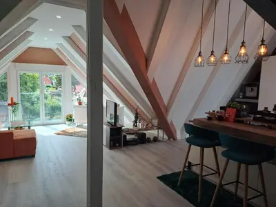 Ein Sitzbereich in der Unterkunft DESIGN-LOFT Brockenblick -Netflix-Smart TV-WLAN-Wallbox-Kaffeevollautomat-Balkon- Panoramaaussicht-Getränke-Pizza-Snacks