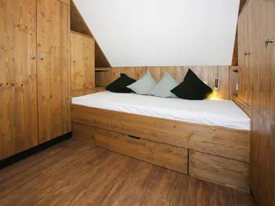 Ein Bett oder Betten in einem Zimmer der Unterkunft Ferienhäuser, Torfhaus Harz