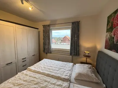 Ein Bett oder Betten in einem Zimmer der Unterkunft Ferienwohnung Harzpause mit Balkon & Sauna - Ferienresidenz Wurmbergblick
