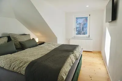 Ein Bett oder Betten in einem Zimmer der Unterkunft FeWo27 im Sagenharz - 4 Sterne DTV - stilvolles Family-Apartment, 2 SZ, Klima, WLAN & Netflix