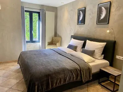 Ein Bett oder Betten in einem Zimmer der Unterkunft country-suites by verdino LIVING - Apartments & Privatzimmer