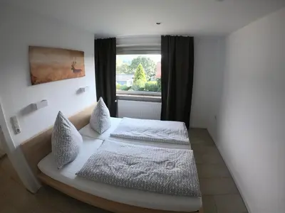 Ein Bett oder Betten in einem Zimmer der Unterkunft Ferienhaus Goethestrasse