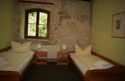 Ein Bett oder Betten in einem Zimmer der Unterkunft Hotel Gasthaus Weisser Mönch