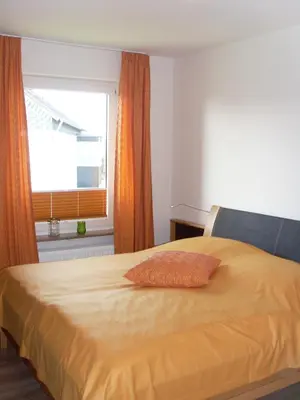 Ein Bett oder Betten in einem Zimmer der Unterkunft Ferienwohnungen Lübbers