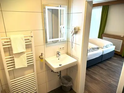 Ein Bett oder Betten in einem Zimmer der Unterkunft Berghotel Glockenberg