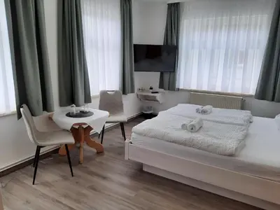 Ein Bett oder Betten in einem Zimmer der Unterkunft Gasthaus Brockenhėxe mit Restaurant & Café