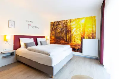 Ein Bett oder Betten in einem Zimmer der Unterkunft Mythenresort Heimdall