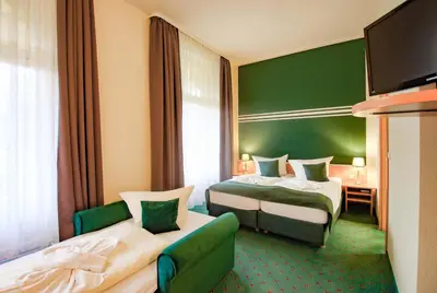 Ein Bett oder Betten in einem Zimmer der Unterkunft Ferien Hotel Villa Südharz