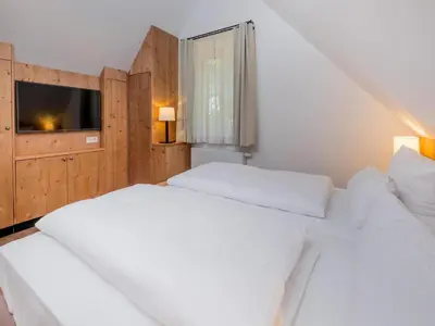 Ein Bett oder Betten in einem Zimmer der Unterkunft Ferienhäuser, Torfhaus