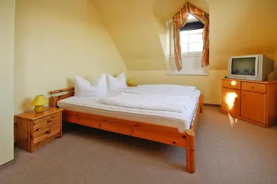 Ein Bett oder Betten in einem Zimmer der Unterkunft Ferienhäuser im Tannenpark, Tanne