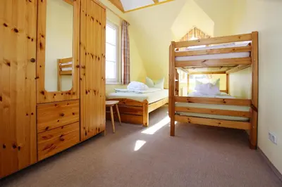 Ein Bett oder Betten in einem Zimmer der Unterkunft Ferienhäuser im Tannenpark, Tanne