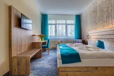 Ein Bett oder Betten in einem Zimmer der Unterkunft Panorama Ferien Hotel Harz