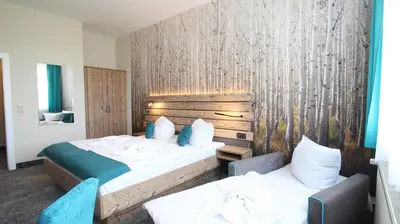 Ein Bett oder Betten in einem Zimmer der Unterkunft Panorama Ferien Hotel Harz