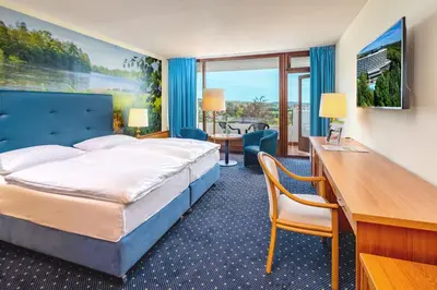 Ein Bett oder Betten in einem Zimmer der Unterkunft AHORN Harz Hotel Braunlage