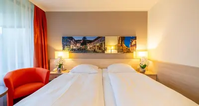Ein Bett oder Betten in einem Zimmer der Unterkunft PLAZA INN Goslar