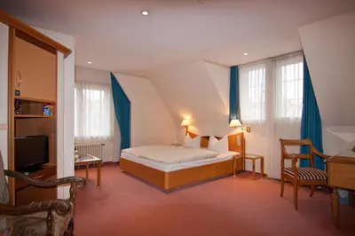 Ein Bett oder Betten in einem Zimmer der Unterkunft Parkhotel Unter den Linden