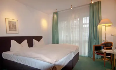 Ein Bett oder Betten in einem Zimmer der Unterkunft Parkhotel Unter den Linden
