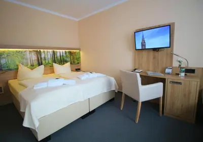 Ein Bett oder Betten in einem Zimmer der Unterkunft Hotel Harzresidenz