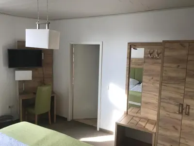 Ein Bett oder Betten in einem Zimmer der Unterkunft Adam`s Schützenhof