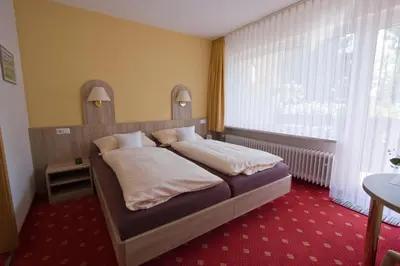 Ein Bett oder Betten in einem Zimmer der Unterkunft Mein Vierjahreszeiten Hotel Garni Superior