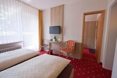 Ein Bett oder Betten in einem Zimmer der Unterkunft Mein Vierjahreszeiten Hotel Garni Superior
