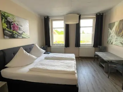 Ein Bett oder Betten in einem Zimmer der Unterkunft Ferienwohnungen LpP Bad Suderode
