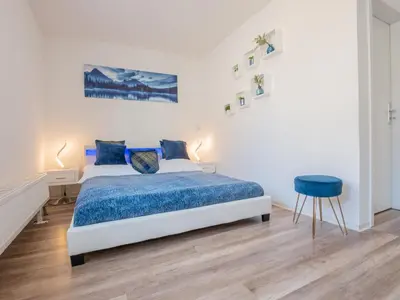 Ein Bett oder Betten in einem Zimmer der Unterkunft EUPHORAS - Top ausgestattete Ferienwohnung mit 105 qm und 3 Schlafzimmern
