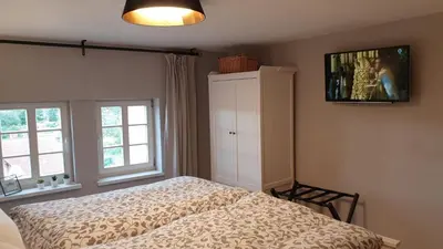 Ein Bett oder Betten in einem Zimmer der Unterkunft Ferienhaus Tor zum Münzenberg