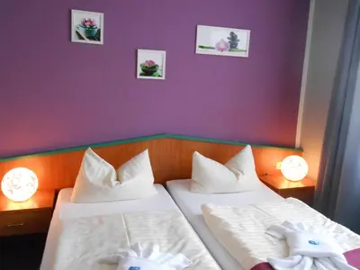 Ein Bett oder Betten in einem Zimmer der Unterkunft Ferienhotel Forelle Thale Ortsteil Treseburg