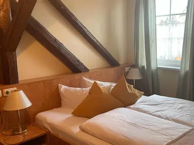 Ein Bett oder Betten in einem Zimmer der Unterkunft Harzhotel Warnstedter Krug