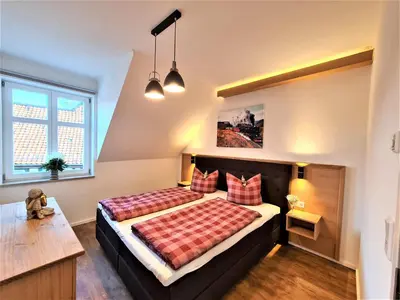 Ein Bett oder Betten in einem Zimmer der Unterkunft Ferienwohnungen Burgfried