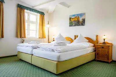 Ein Bett oder Betten in einem Zimmer der Unterkunft Hotel & Restaurant Brauner Hirsch Osterwieck