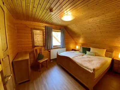 Ein Bett oder Betten in einem Zimmer der Unterkunft Ferienhaus im Naturerlebnisdorf Blauvogel