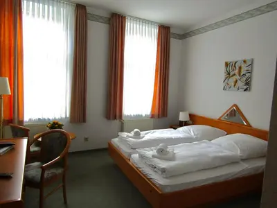 Ein Bett oder Betten in einem Zimmer der Unterkunft Pension Hexenkessel